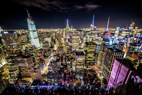 A bustling city skyline at night, highlighting popular travel spots.