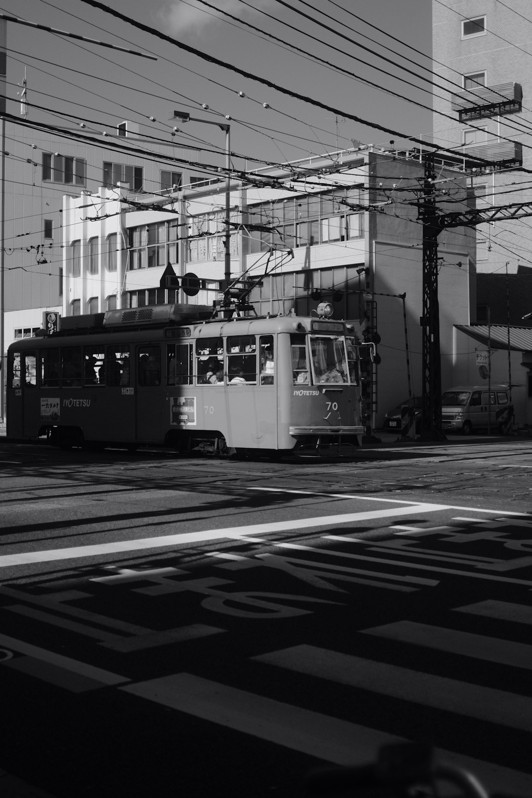 grayscale photo of tram on road