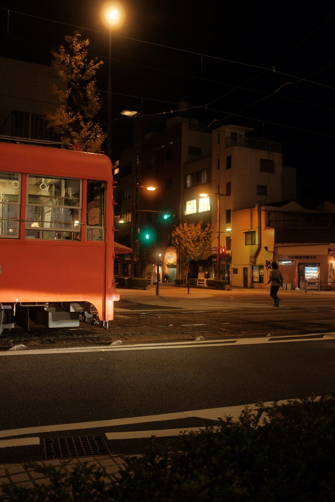 red bus on the road during night time
