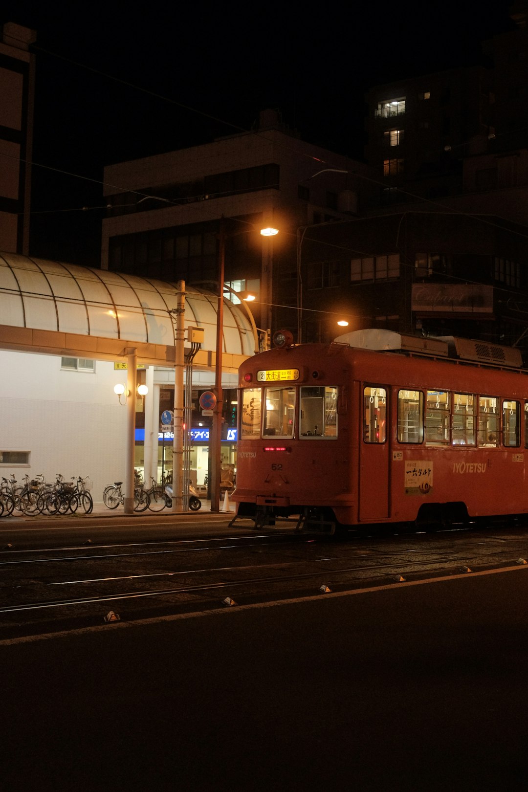 white and brown train on rail during night time