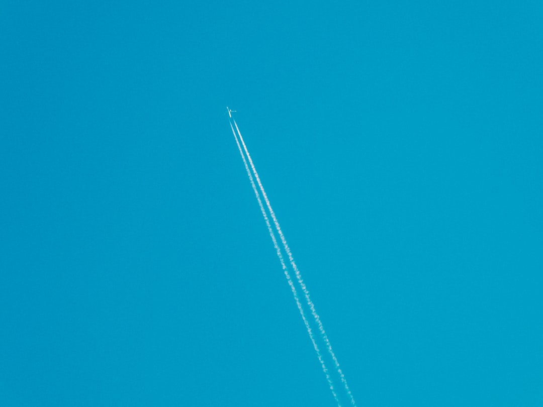 white plane in the sky,