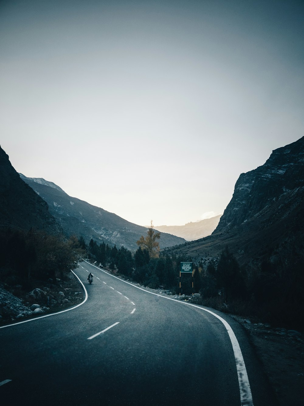 gray asphalt road between mountains during daytime