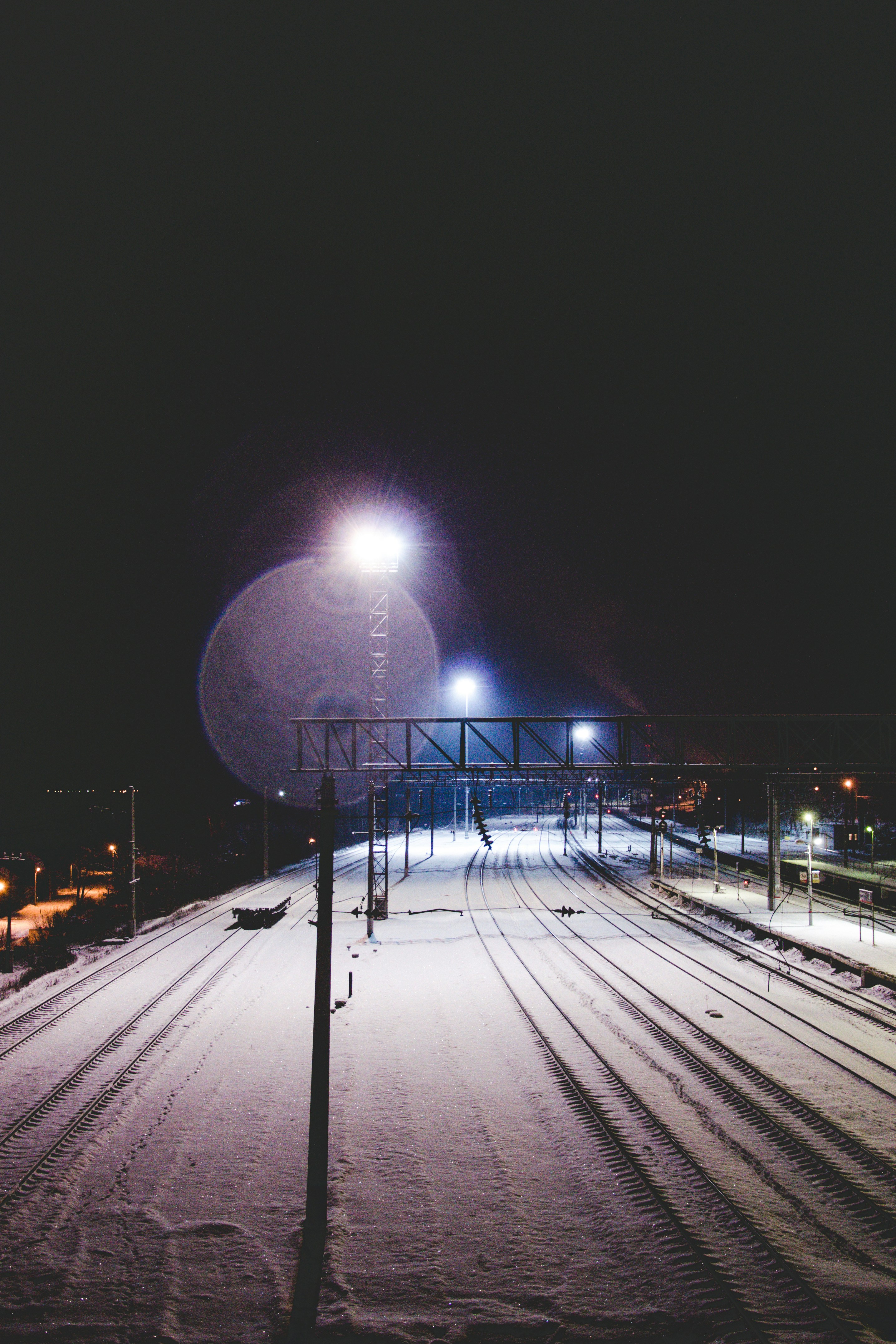 gray metal railings near road during night time
