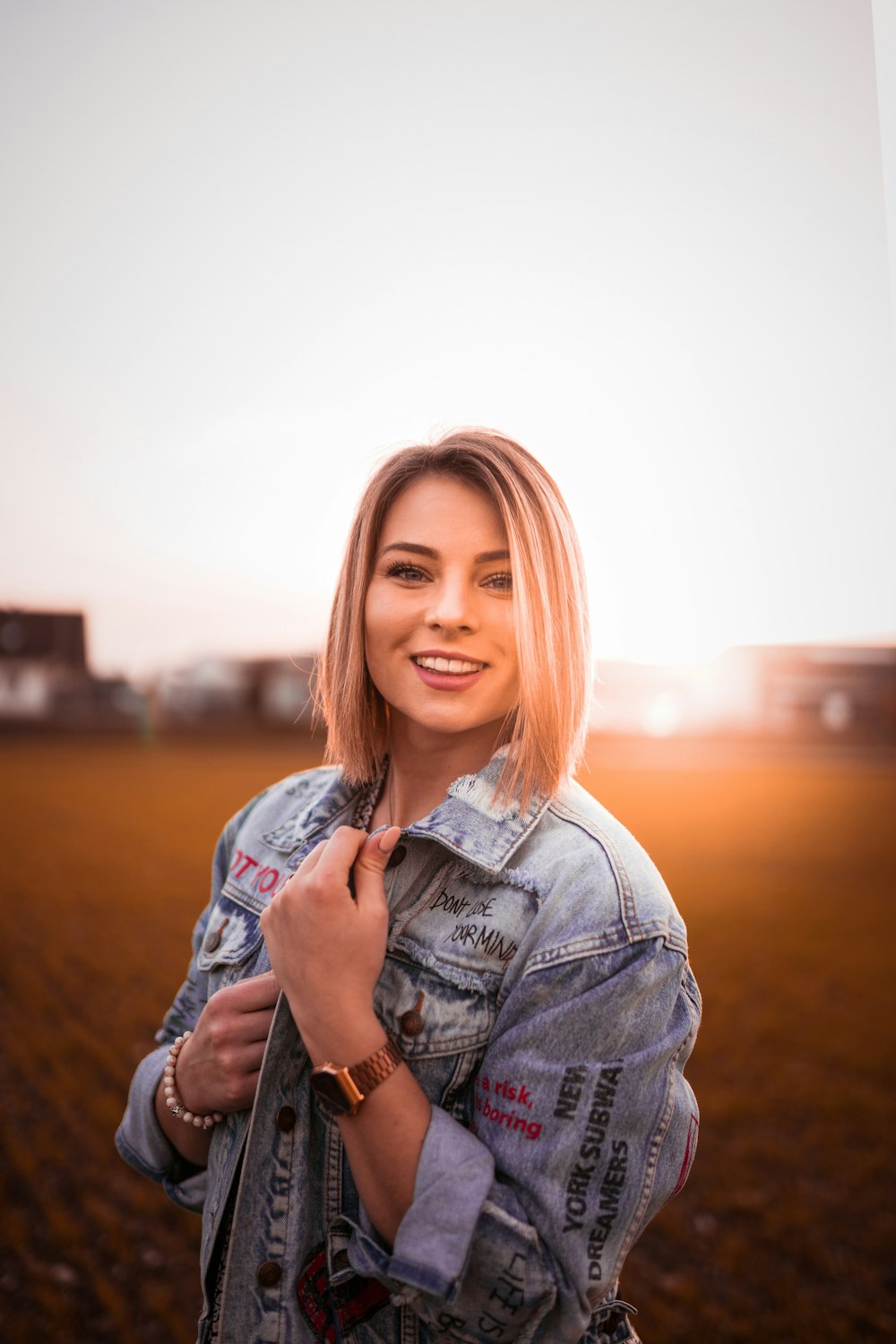 woman in blue denim jacket smiling