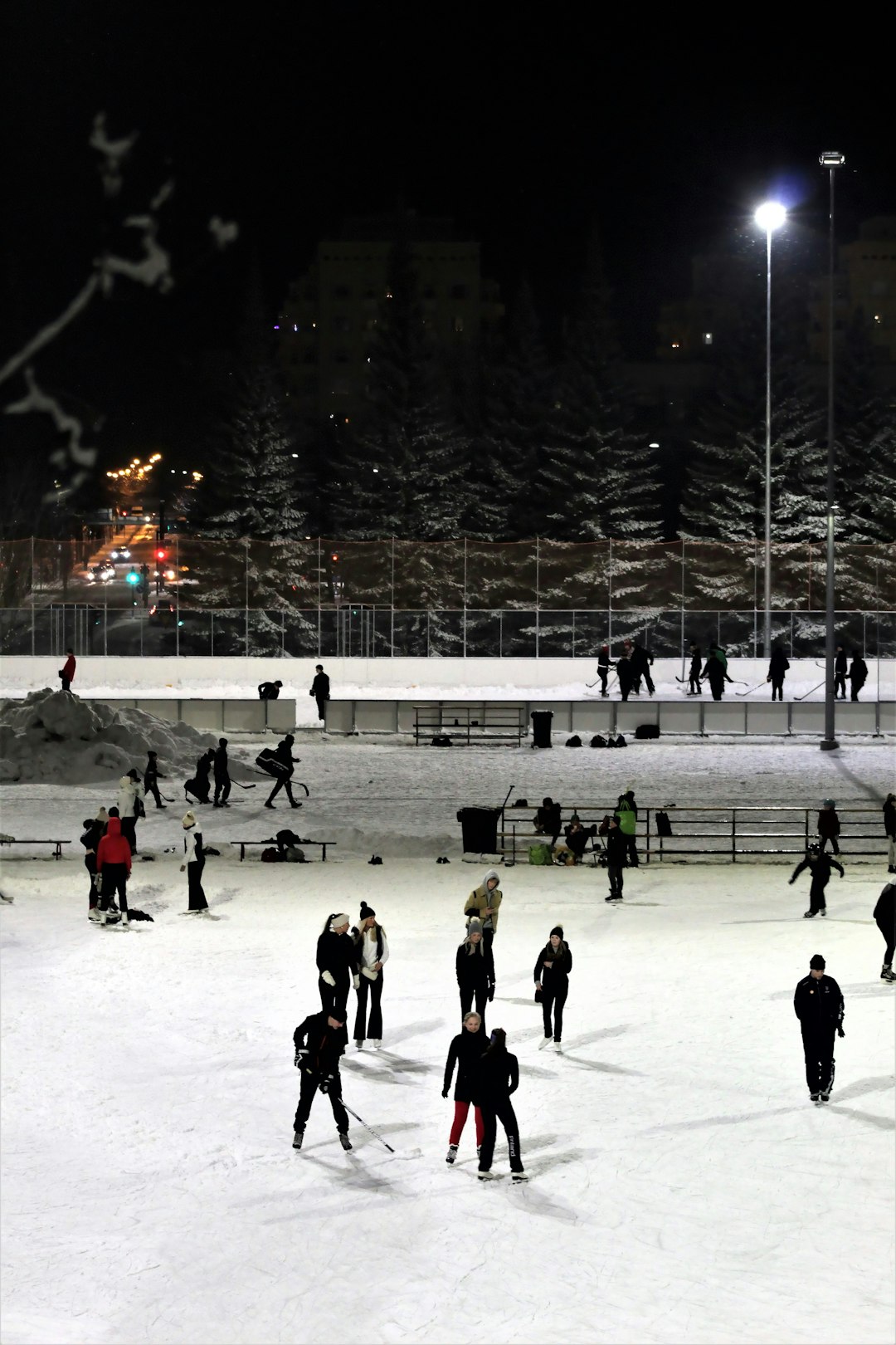  people playing ice hockey during nighttime match stick