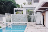 white concrete house near swimming pool during daytime