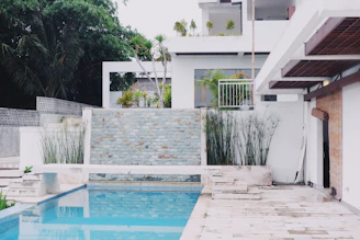 A beautifully paved patio area with natural stone textures complementing a pool.