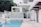 A modern poolside area featuring a sleek, non-slip stone resin surface under bright sunlight.