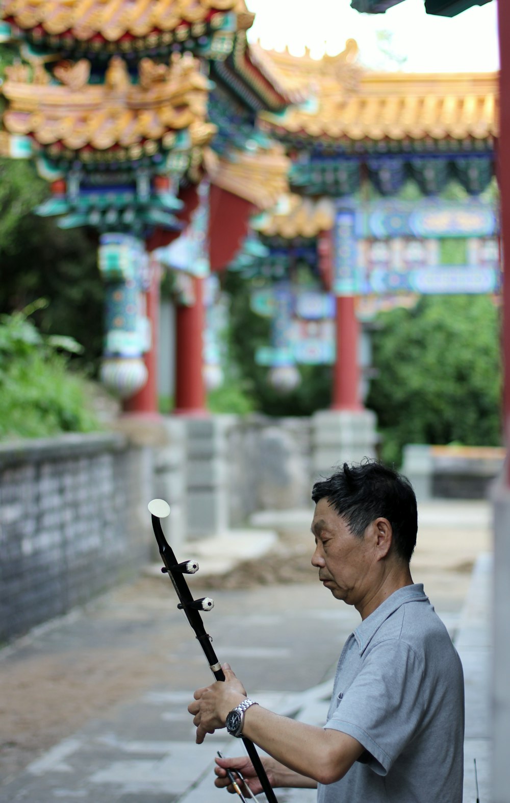 man in white shirt playing guitar