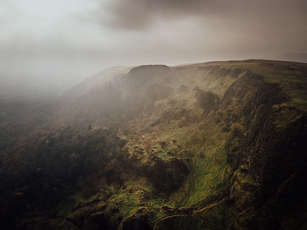 green and brown mountain under white clouds