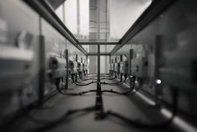 Wide-angle view of a data center floor with polished white floors and subtle shadows under the racks.