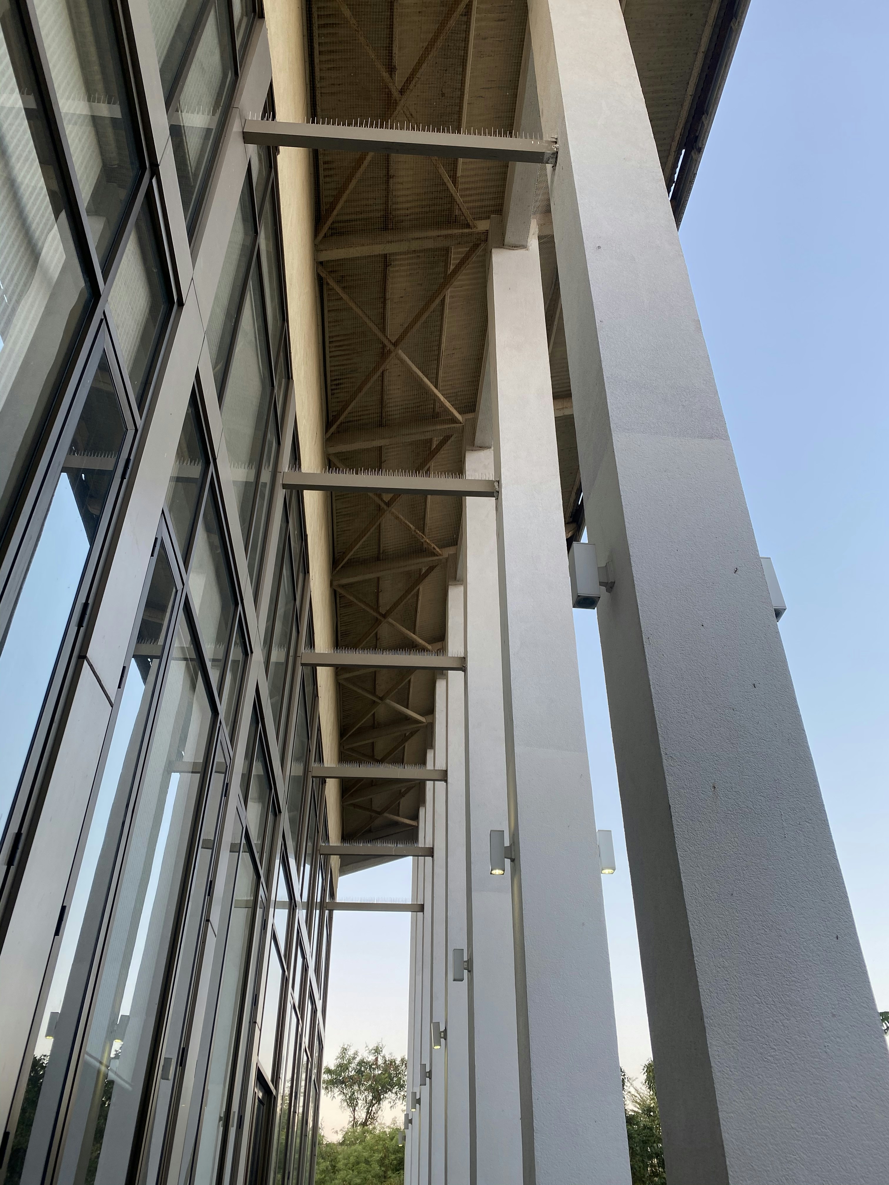Commercial building exterior brick facade, modern architecture, structural masonry, bright sky