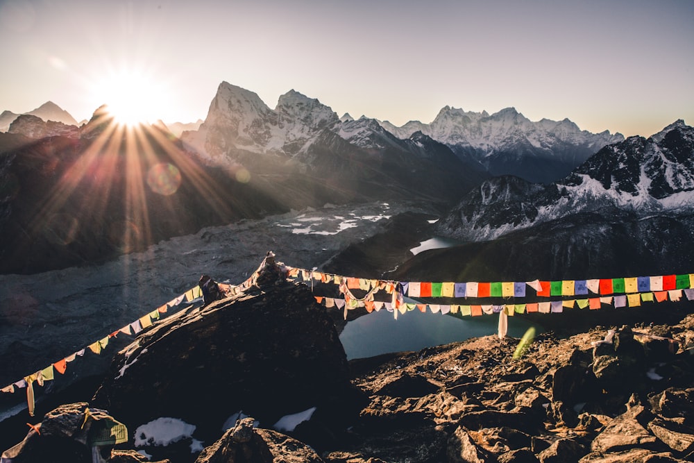 a long line of colorful flags on top of a mountain