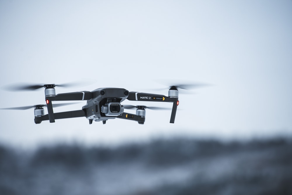 black and white drone in mid air