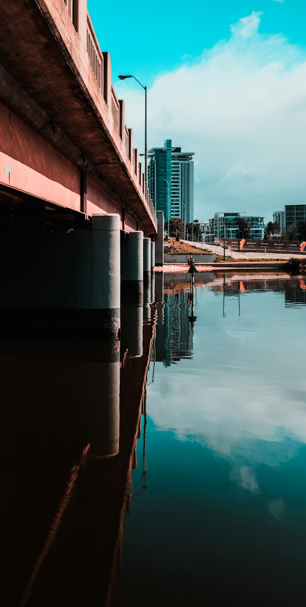 brown and white concrete building near body of water during daytime