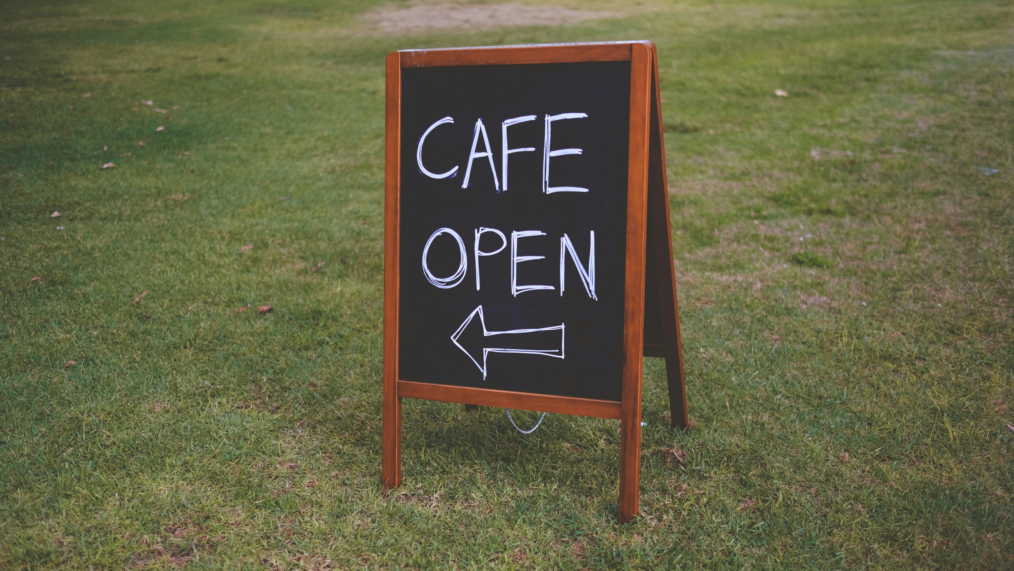 brown wooden framed black and white wooden signage
