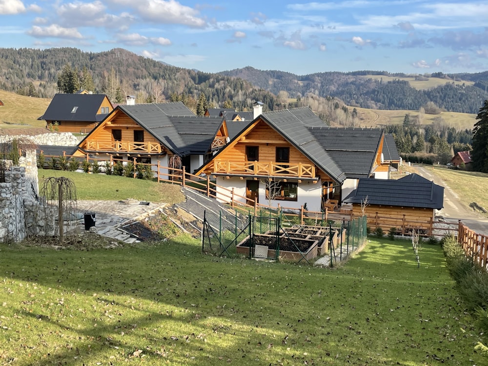 brown wooden house on green grass field during daytime