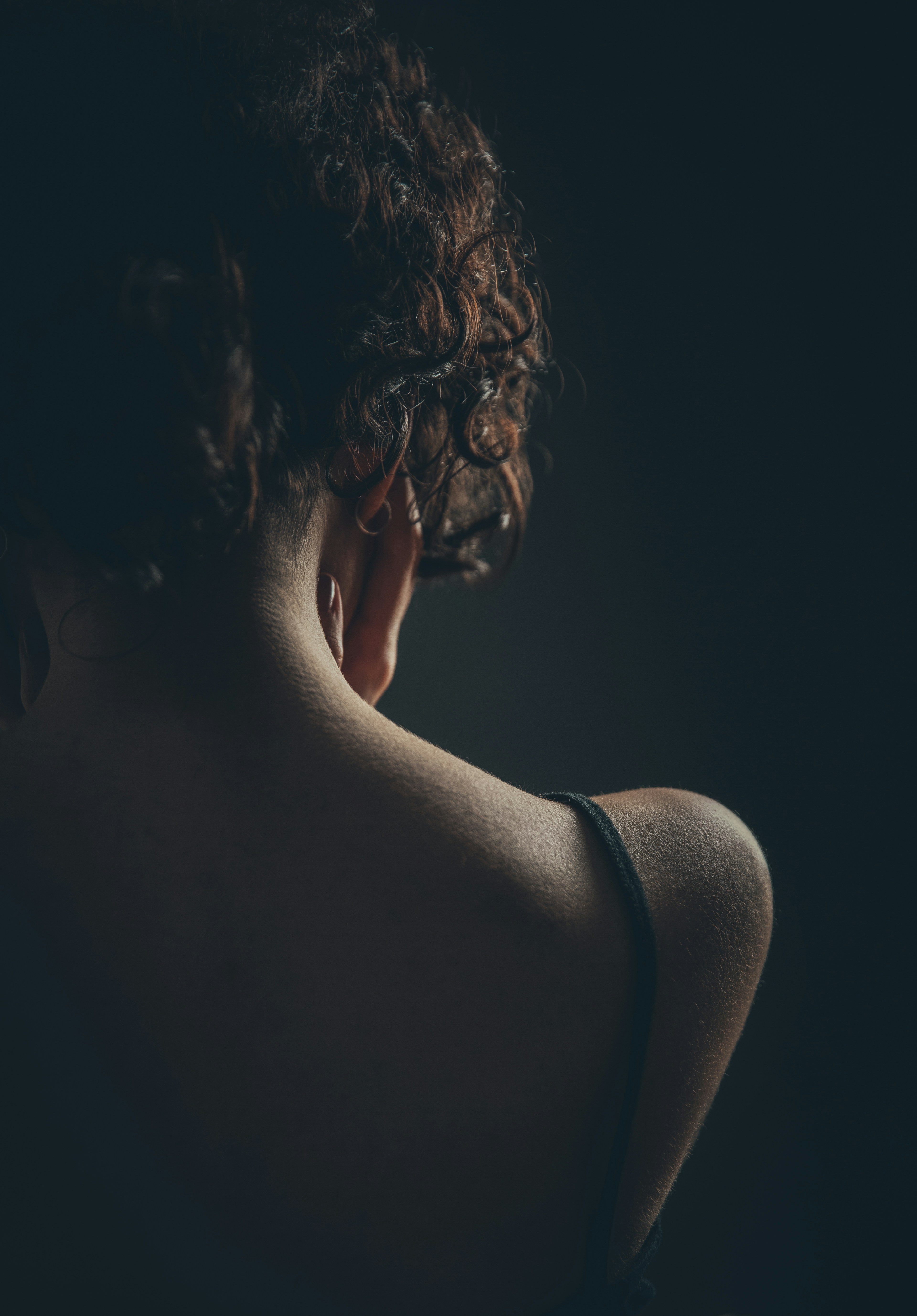 woman with brown hair looking down