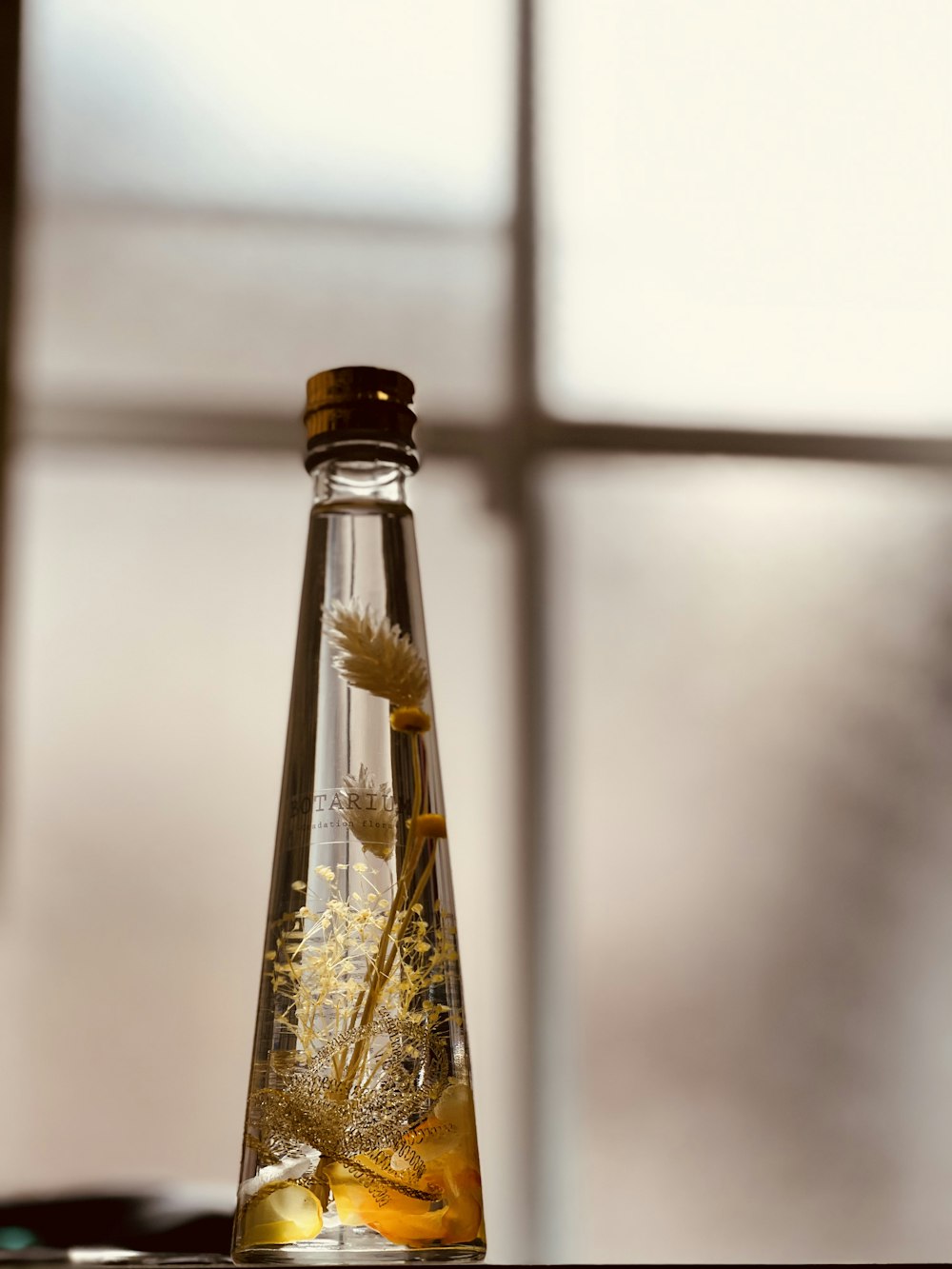 clear glass bottle with brown powder