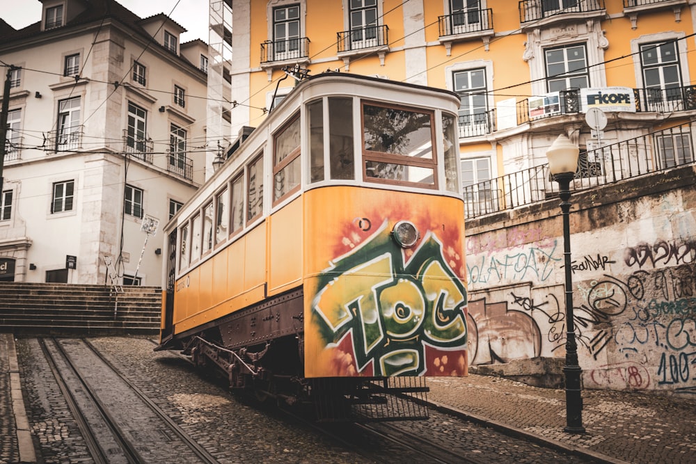 yellow and white train on rail tracks