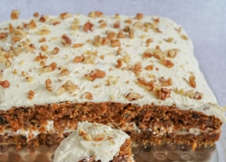 brown and white cake on clear plastic container