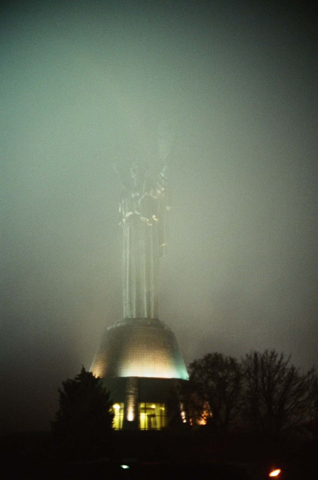 white light tower under gray sky