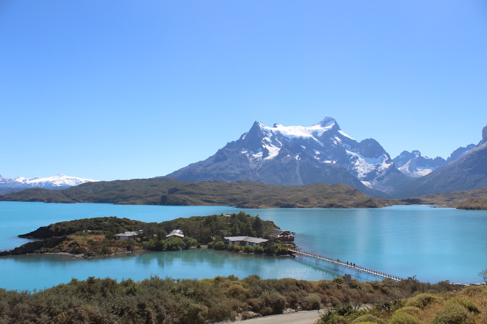 lake near snow covered mountain during daytime