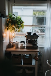 black and silver coffee maker on brown wooden table