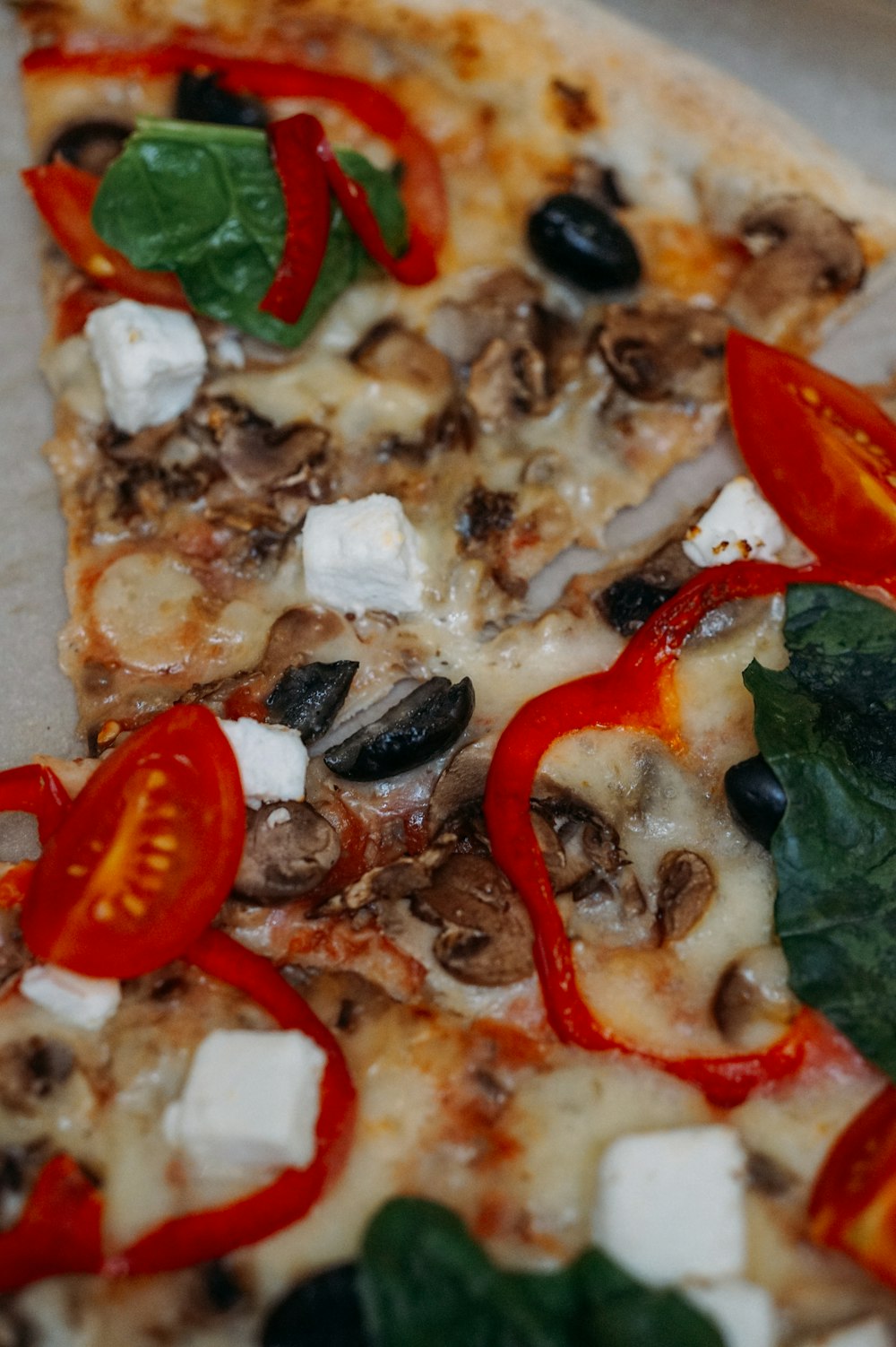 pizza with tomato and green leaf vegetable