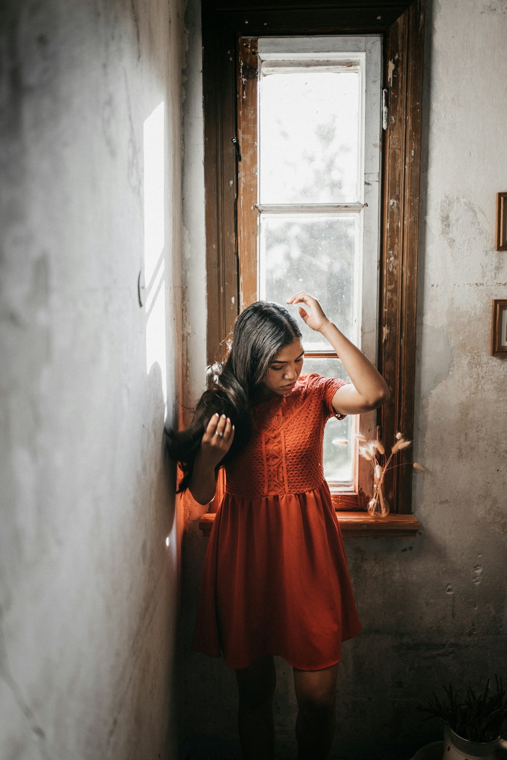 woman in red dress standing on doorway