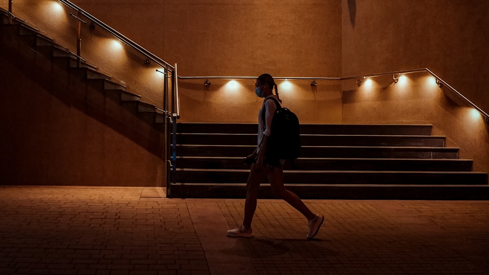 woman in black dress walking on staircase