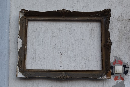 brown wooden frame on white wall
