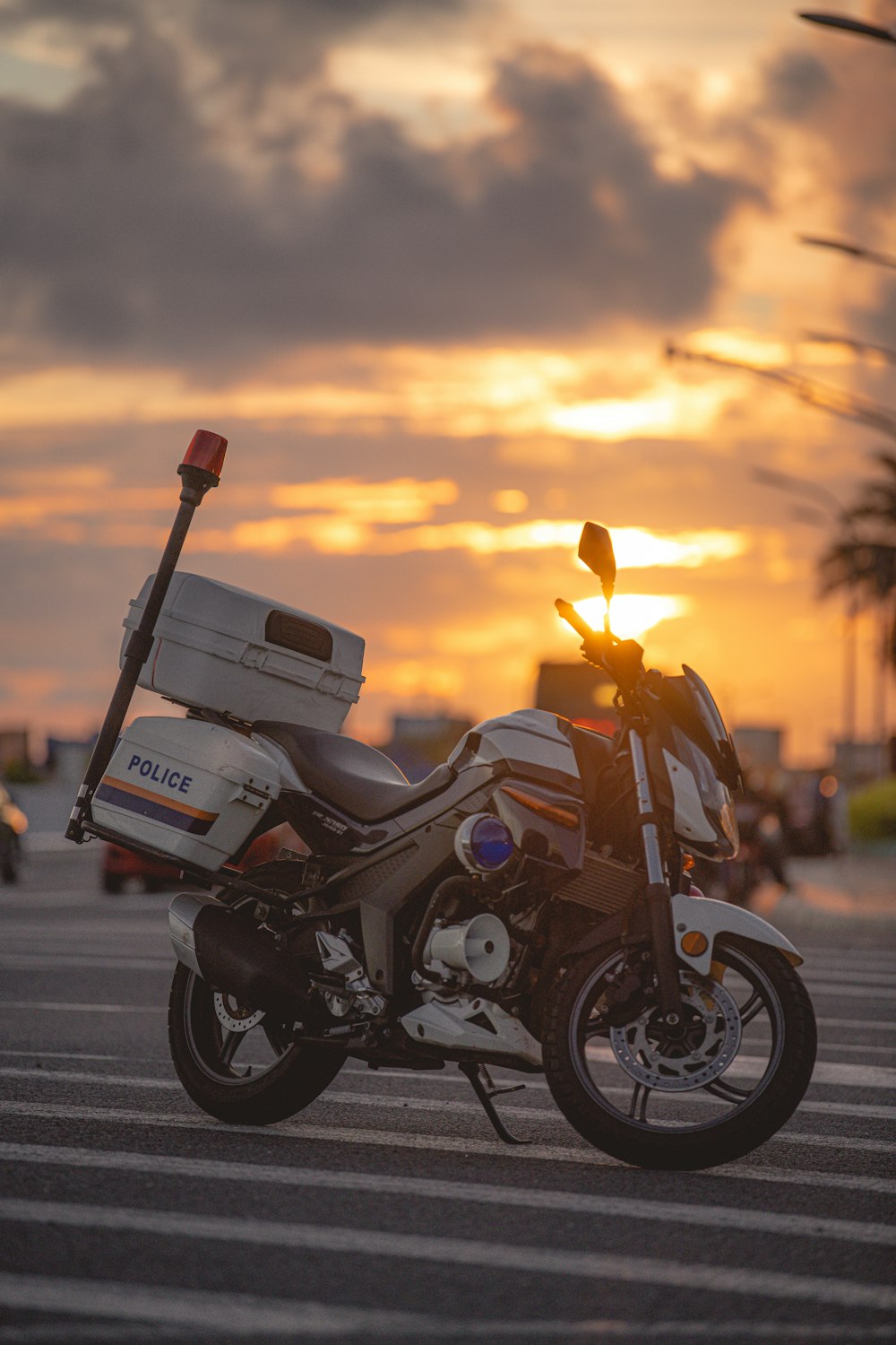 white and black motorcycle on road during sunset