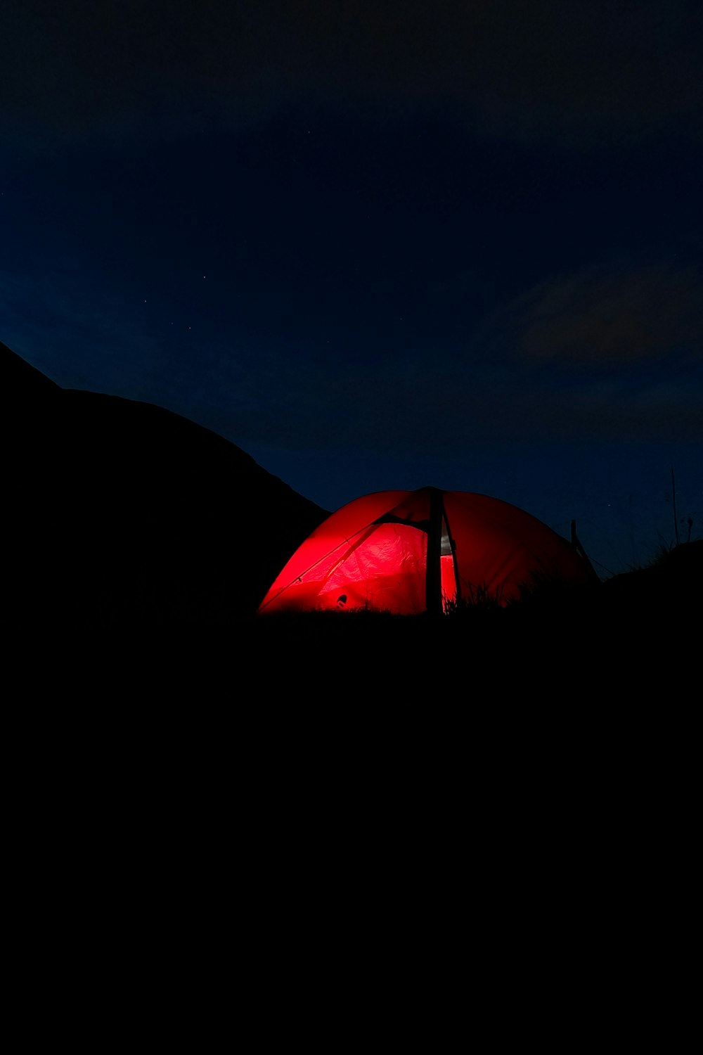 orange dome tent on green grass field during night time
