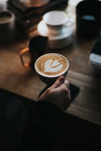 person holding cup of coffee