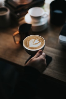 person holding cup of coffee