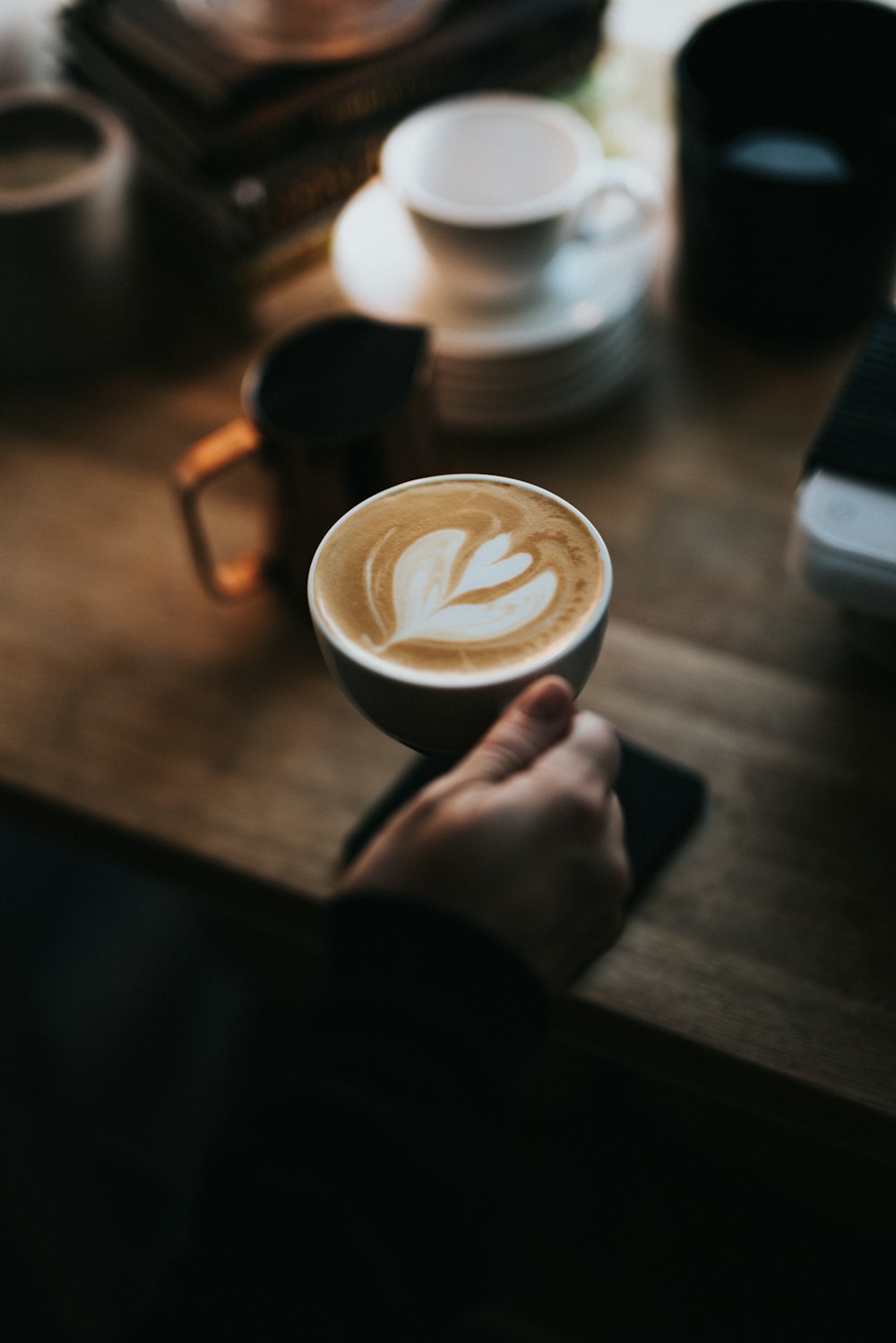 person holding cup of coffee