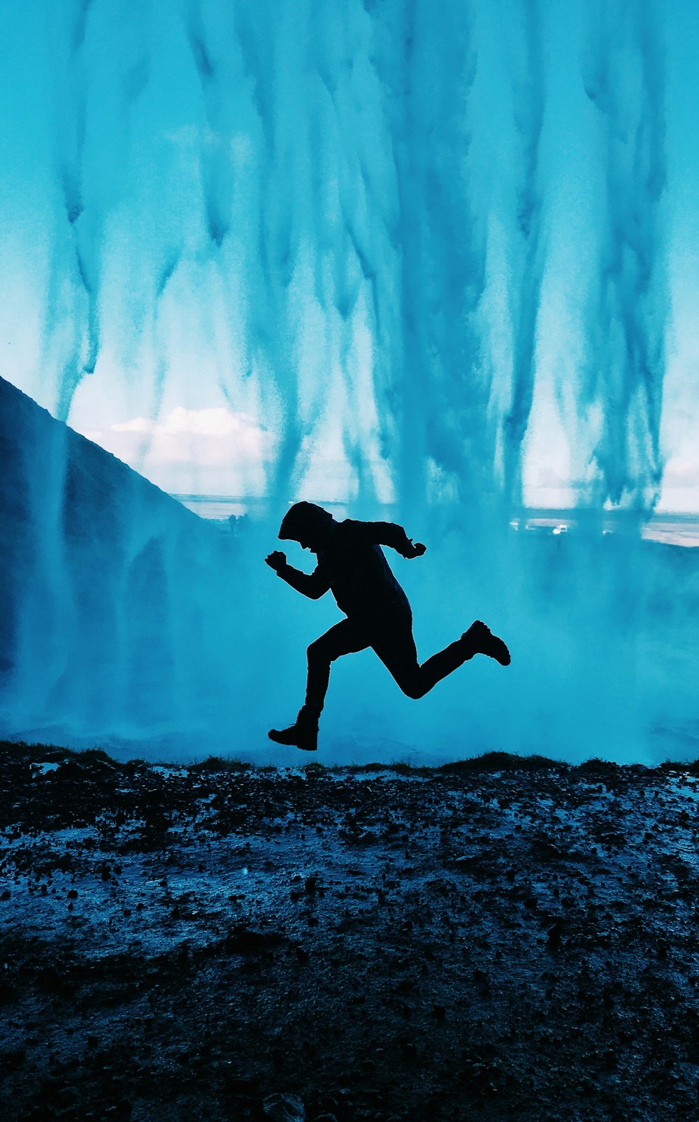 man in black pants jumping on water