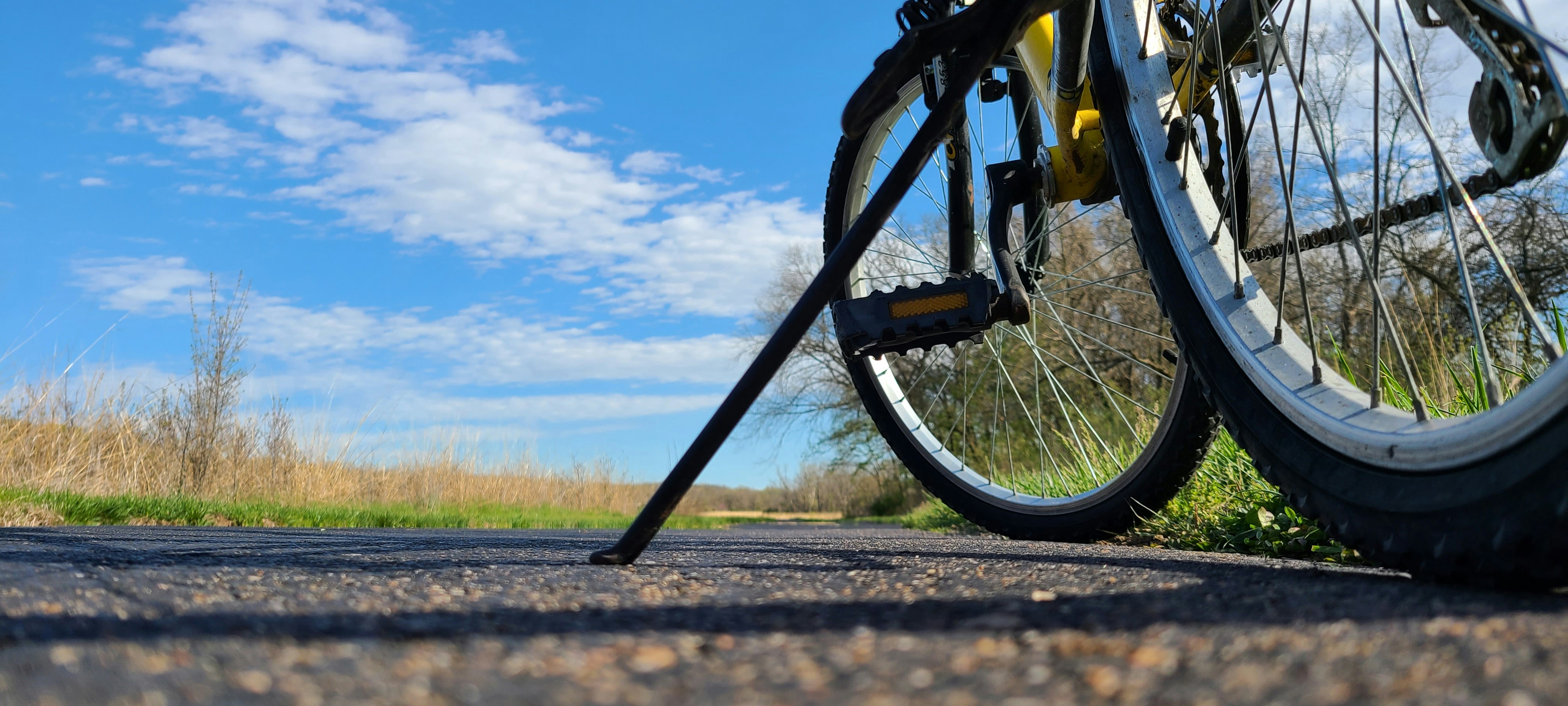 black bicycle on brown dirt road during daytime