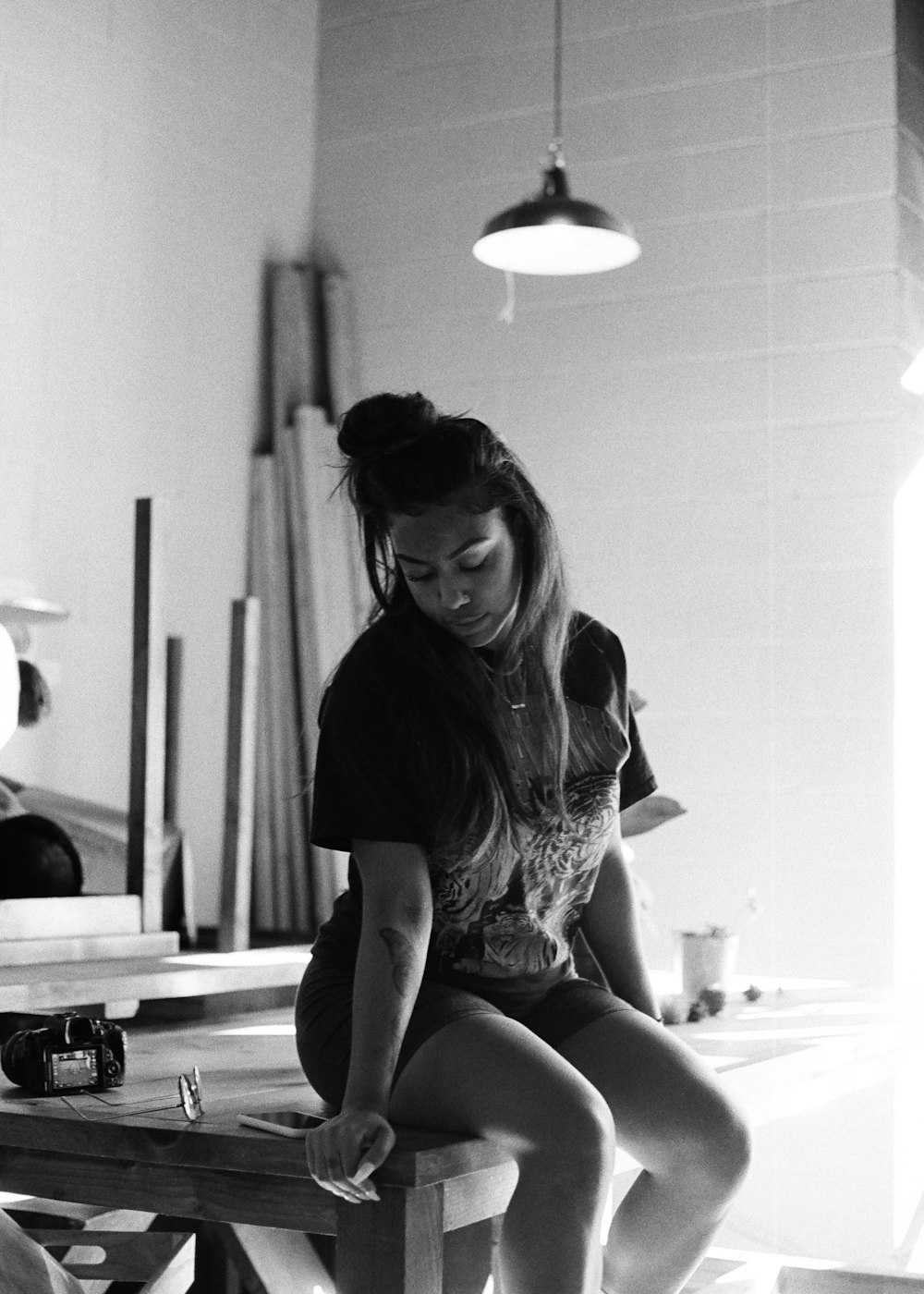 woman in black shirt sitting on table