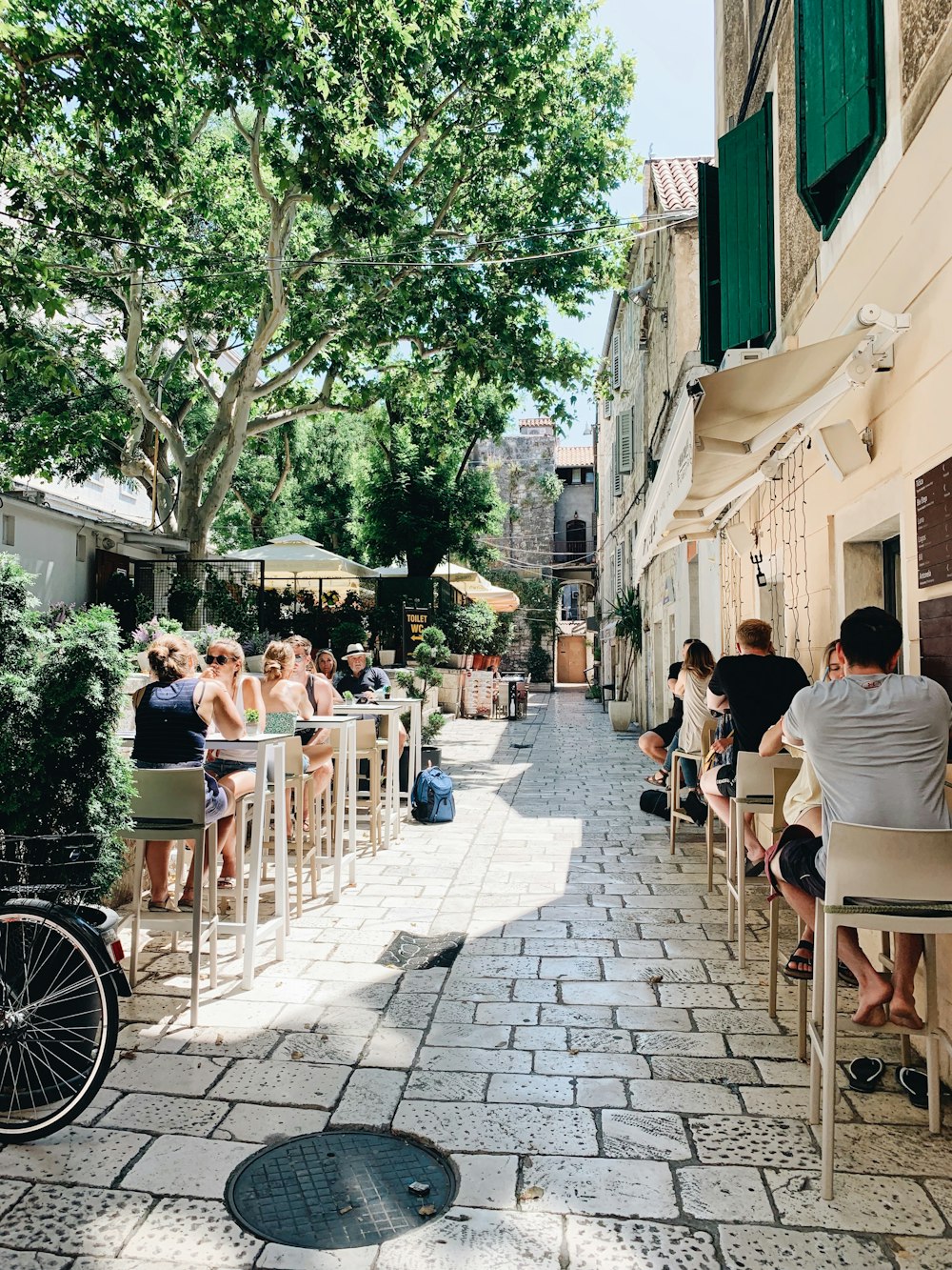 people sitting on chairs near building during daytime