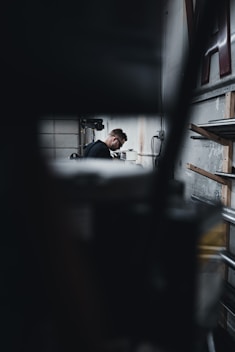 man in black shirt sitting on chair
