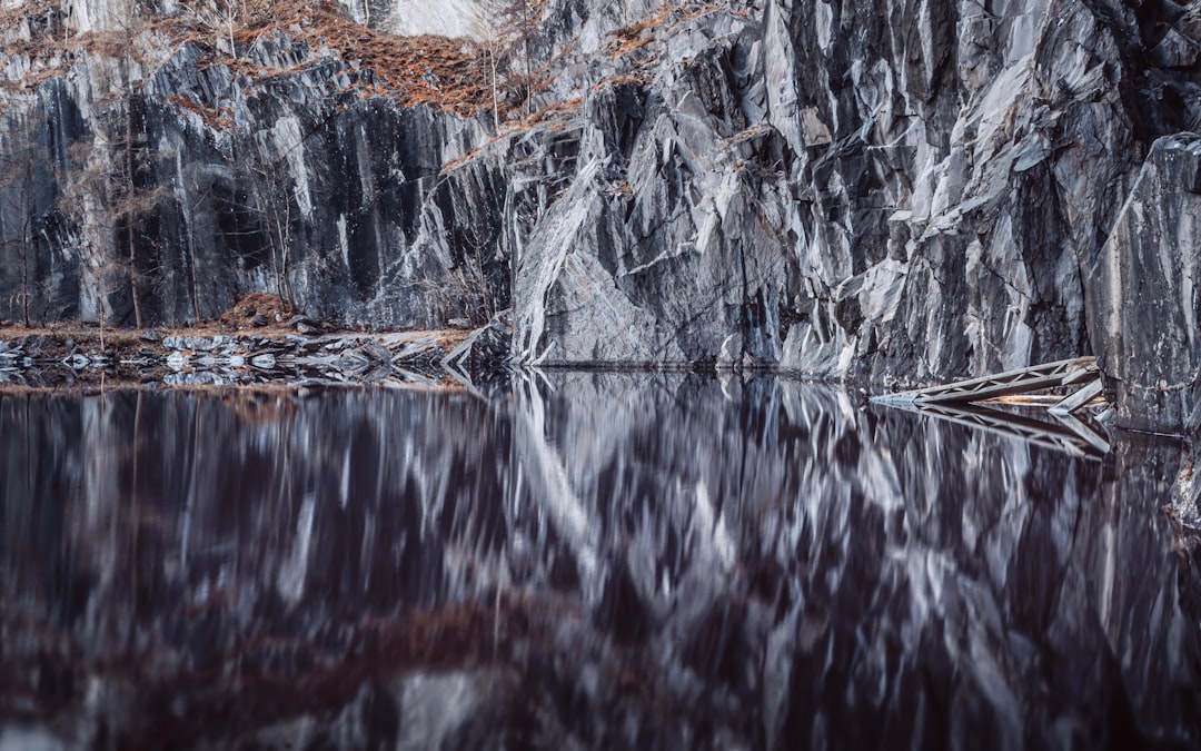 brown and white rock formation on water