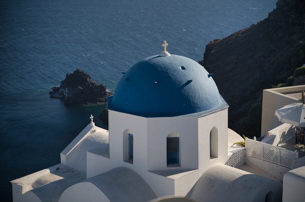 white and blue dome building near body of water during daytime