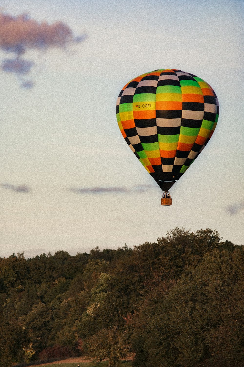yellow red and blue hot air balloon on mid air during daytime