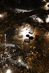 Robust outdoor steel furniture set arranged on a patio under soft lighting.