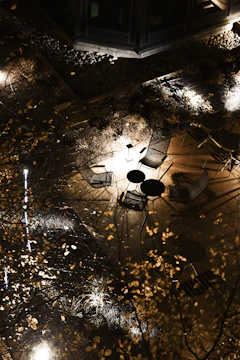 Robust outdoor steel furniture set arranged on a patio under soft lighting.