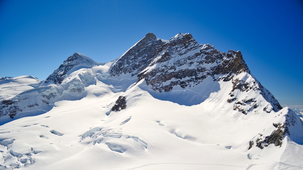 snow covered mountain under blue sky during daytime