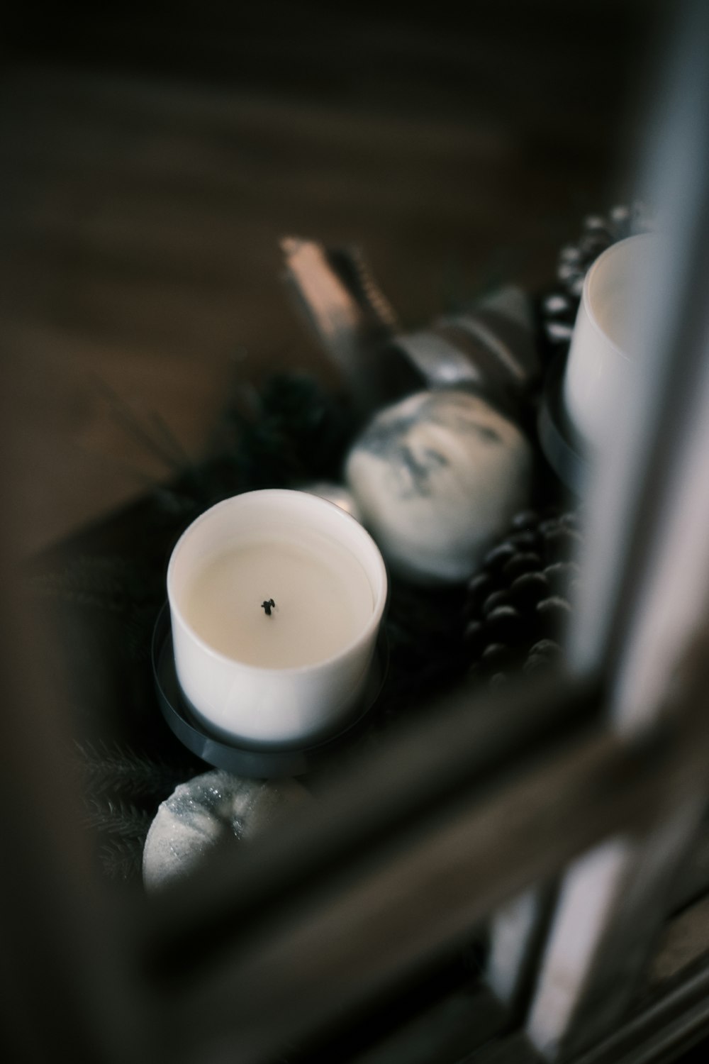 white pillar candle on brown wooden table