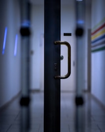 black metal door lever in close up photography